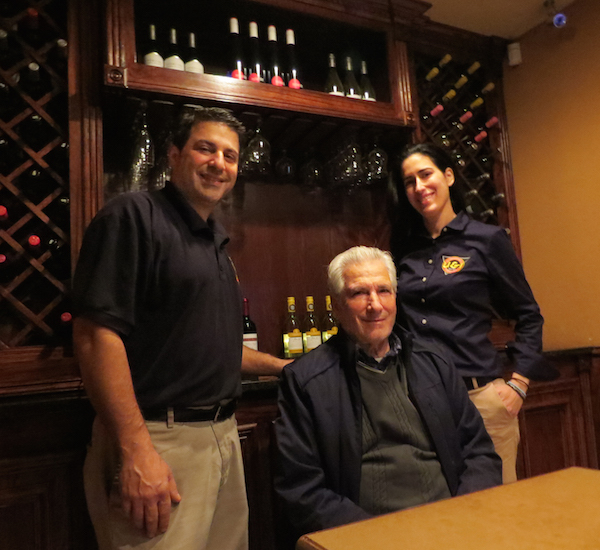 Bill and Sophia Piperis, the newest generation of the family to work at U & I Restaurant, stand by owner and founder, George Piperis near a selection of their fine wines. Staff Photo