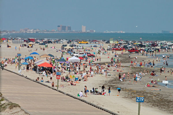 Spring Break crowds enjoy a sunny day along Padri Balli Beach near Bob Hall Pier in Corpus Christi in March 2010. Spring Break will stretch over two weeks this year and draw more visitors than in years past, according to a spokesman from the Convention and Visitors Bureau. Photo by Jon Brandt