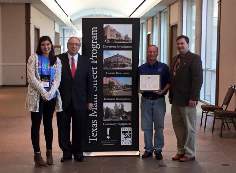 The Corpus Christi Downtown Management District is now the largest city in the Texas Main Street Program. Receiving — and presenting — the official designation are (from left) Hannah Shaw, DMD merchant and special events coordinator; John Crain, Texas Historical Commission vice chairman; Terry Sweeney, DMD executive director; and Brad Patterson, THC community heritage development division. Courtesy Photo