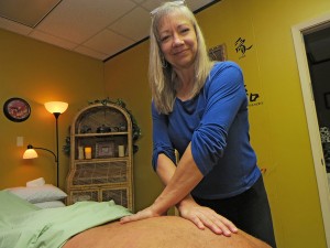 Beverly Montuori practices myofascial release on a client in her massage therapy studio at 5700 S. Staples in the Atrium Office, Suite F2C.