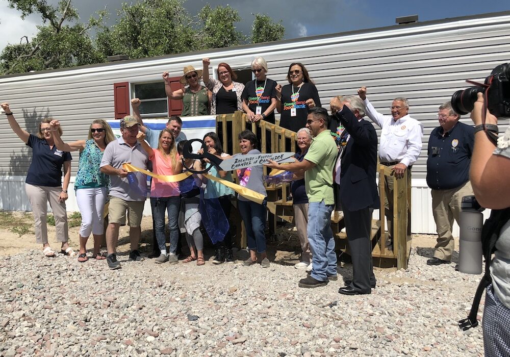 Jannet Bardwell and her two grandchildren receive the keys to their new manufactured home in Fulton from the Coastal Bend Disaster Recovery Group. The Coastal Bend Food Bank and other organizations that helped in putting this family back in a home were also on hand to celebrate. Courtesy photo