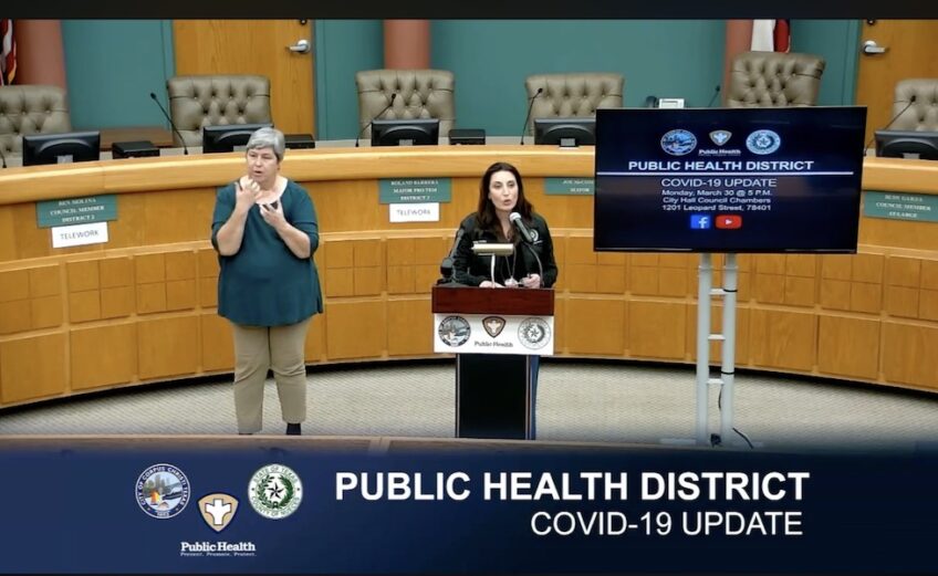 Nueces County Judge Barbara Canales announced the county’s new COVID-19 hotline number — 361-441-6000 — as Lucy James interprets her remarks in American Sign Language. Screen capture