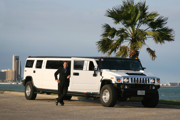 Owner Billy Huerta with one of the luxury vehicles — this one a Hummer — available at 1st Choice Limousines in Corpus Christi. Photo by Carrie Robertson Meyer/Third Coast Photo