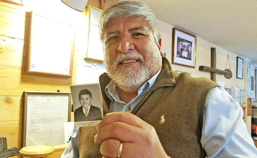 Tony Reyes holds a photo of himself at 5 years old when he attended kindergarten in the same building where he now serves as CEO and founder of Mission 911, a nonprofit organization that helps homeless families get back on their feet. Photo by Jane Kathleen Gregorio