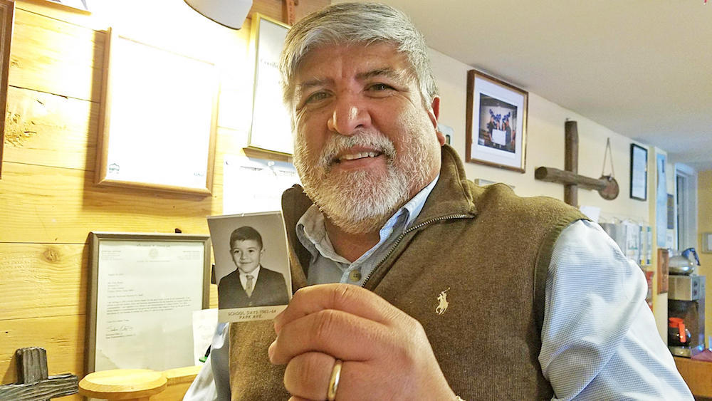 Tony Reyes holds a photo of himself at 5 years old when he attended kindergarten in the same building where he now serves as CEO and founder of Mission 911, a nonprofit organization that helps homeless families get back on their feet. Photo by Jane Kathleen Gregorio