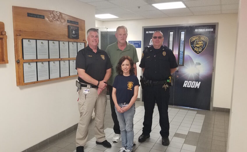 Police volunteer coordinator Tom Brown (left) and Capt. Russell Sherman (right) with volunteers Celeste Hogin and Wayne Bortner at Corpus Christi police headquarters at 321 John Sartain St. in downtown. Photo by Jane Kathleen Gregorio