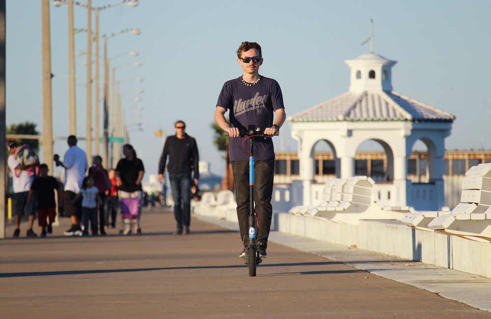 Adrian Garcia, 19, of North Beach in Corpus Christi takes a ride on a Blue Duck scooter along the downtown seawall. Blue Duck is offering free rides throughout January as a promotion. Photo by Carrie Robertson Meyer