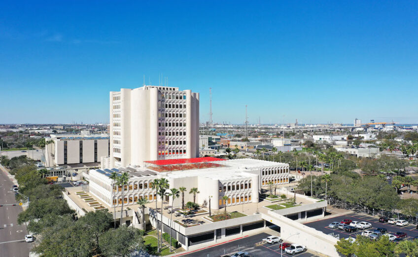 An aerial view of the Nueces County Courthouse at 901 Leopard St. in Corpus Christi. The travertine facade of the building has been deteriorating over the years, leaking rainwater into the interior. Work began in early February to replace 60 percent of the building’s shell. Photo courtesy of LAN