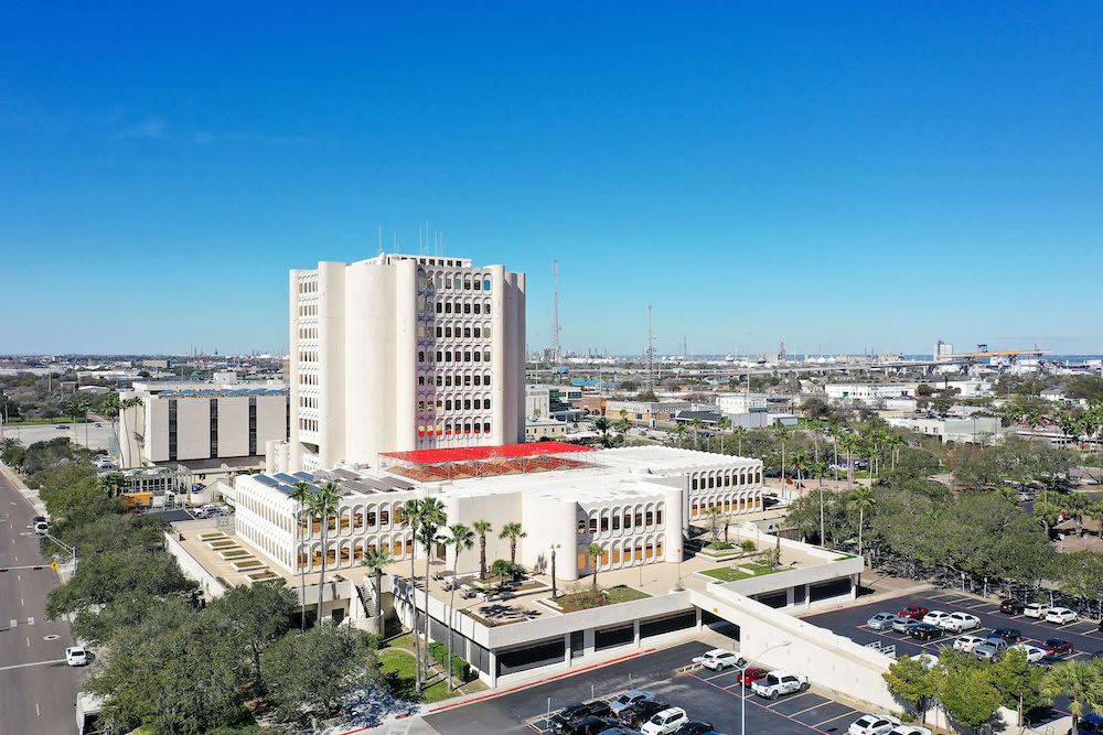 An aerial view of the Nueces County Courthouse at 901 Leopard St. in Corpus Christi. The travertine facade of the building has been deteriorating over the years, leaking rainwater into the interior. Work began in early February to replace 60 percent of the building’s shell. Photo courtesy of LAN