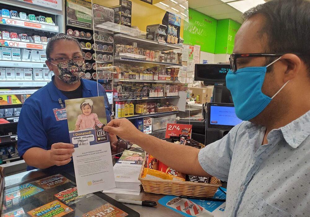 Stripes employee Lupe Lopez assists a customer with filling out the paper icon for Driscoll Children’s Hospital after donating to help sick and injured children in South Texas. Photo by Jane Kathleen Gregorio