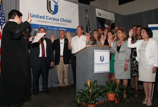 Rosie Gonzalez Collin (right) is sworn in as president of the newly merged Corpus Christi and Hispanic chambers along with the rest of the 31 new board members of the United Corpus Christi Chamber of Commerce. The first meeting of the board and the unveiling of the new members was Aug. 17. Photo by Carrie Robertson Meyer/Third Coast Photo