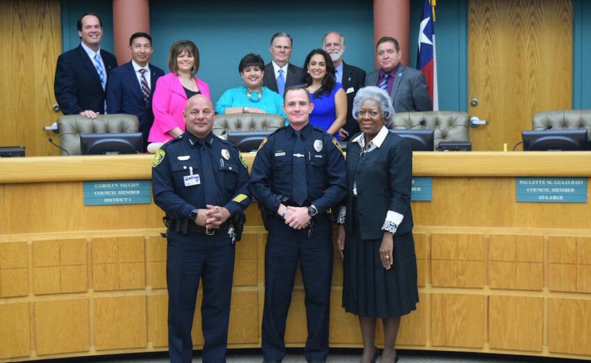 An eight-member council will soon have a new mayor and a new at-large city council member just in time for budget season. In this photo, the current members of the council stand behind the dais as Corpus Christi police officer Skyler Barker (front, center) was recognized by City Manager Margie C. Rose (front, left) and Police Chief Mike Markle (front, right) at a recent City Council meeting. Officer Barker has received the distinction of Corpus Christi's ‘Police Officer of the Year’ and Kiwanis International Club of Corpus Christi’s ‘Chief Floyd Simpson Police Officer of the Year.’ Council members are (back row, from left) Michael Hunter, Ben Molina, Carolyn Vaughn, Lucy Rubio, Joe McComb, Paulette M. Guarjardo, Greg Smith and Rudy Garza Jr. Courtesy photo