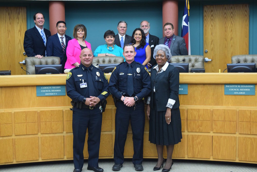 An eight-member council will soon have a new mayor and a new at-large city council member just in time for budget season. In this photo, the current members of the council stand behind the dais as Corpus Christi police officer Skyler Barker (front, center) was recognized by City Manager Margie C. Rose (front, left) and Police Chief Mike Markle (front, right) at a recent City Council meeting. Officer Barker has received the distinction of Corpus Christi's ‘Police Officer of the Year’ and Kiwanis International Club of Corpus Christi’s ‘Chief Floyd Simpson Police Officer of the Year.’ Council members are (back row, from left) Michael Hunter, Ben Molina, Carolyn Vaughn, Lucy Rubio, Joe McComb, Paulette M. Guarjardo, Greg Smith and Rudy Garza Jr. Courtesy photo