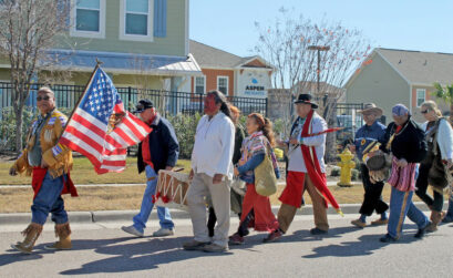 Members of the South Texas Alliance of Indigenous People march along Ennis-Joslin Road in Corpus Christi on Jan. 13. The annual procession honors the Native Americans who were buried there over the past 2,000 years. The area is the second-largest burial ground in Texas. Photo by Chris deLong