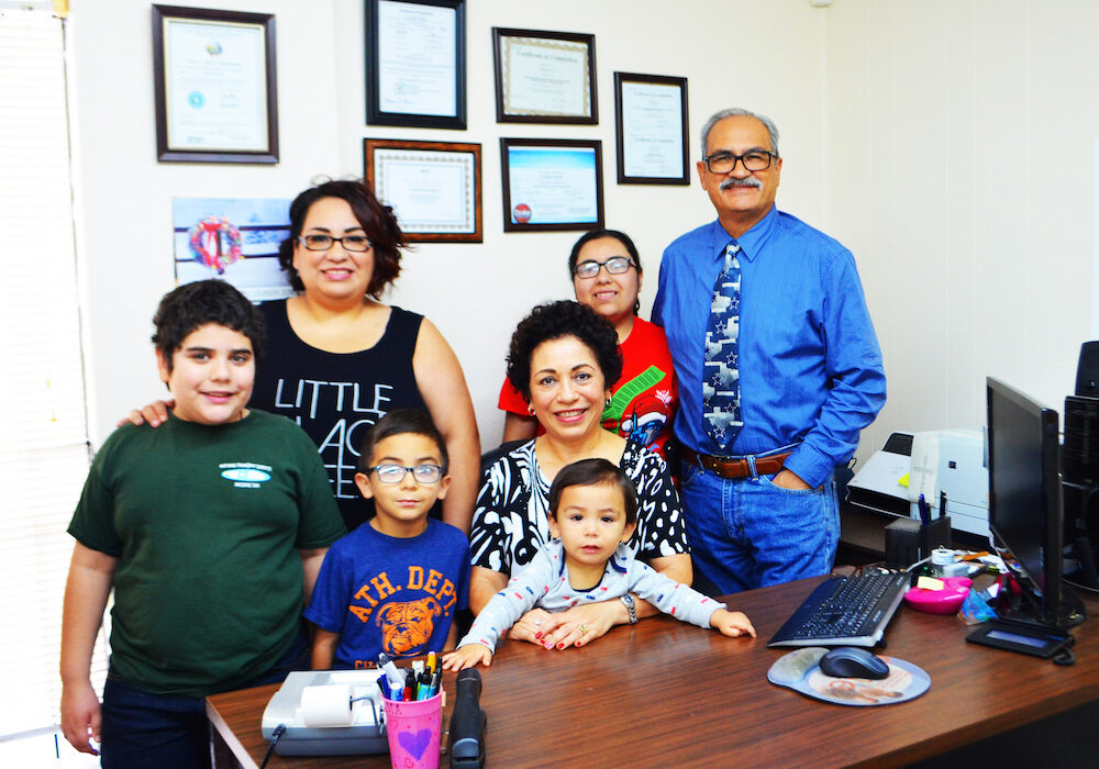 The Refund Transmit Service family includes (front, from left) grandsons Oscar Gonzales, Omar Perez and Orion Perez; (rear, from left) daughter Monica Perez, granddaughter Olivia Gonzales, founder Oscar Garcia and (center) co-owner Cynthia Garcia. Photo by Jane Kathleen Gregorio