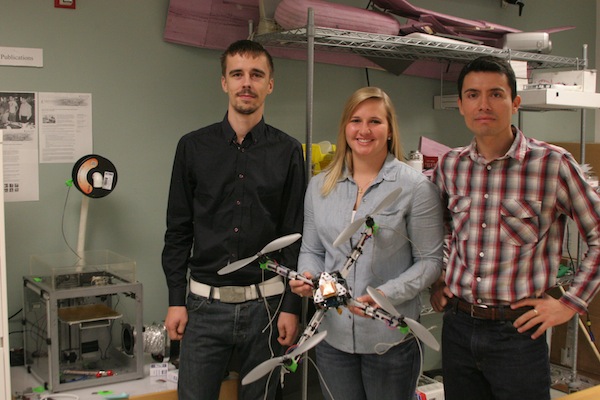 Cristoph Hintz (left), Lindsey Biehler and Professor Dr. Luis Garcia in Dr. Luis' lab at Texas A&M University-Corpus Christi with one of their homemade drones. Staff Photo