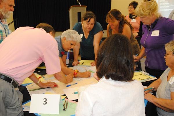 Corpus Christi Mayor Nelda Martinez (center) participates in a summer workshop to outline a 20-year plan for the city’s future. Members of the public were invited to attend eight open houses in November 2014 to go over a draft of Plan. Courtesy Photo