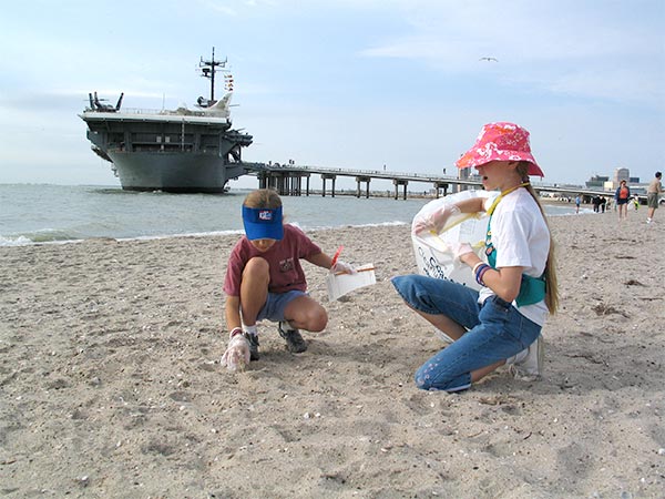 Volunteers clean up along North Beach in Corps Christi alongside the USS Lexington Museum on the Bay at a 2013 event. A regional cleanup is set for Feb. 7 at six different locations in the Coastal Bend, including North Beach. Check-in for North Beach is 8: