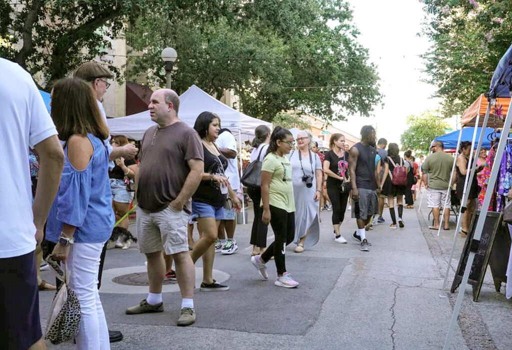 Popup tents provided plenty of space for vendors to offer their wares in an outdoor setting at a past Corpus Christi ArtWalk. Visitors enjoy tasty Texas treats while shopping and listening to live music at the monthly event. Courtesy photo