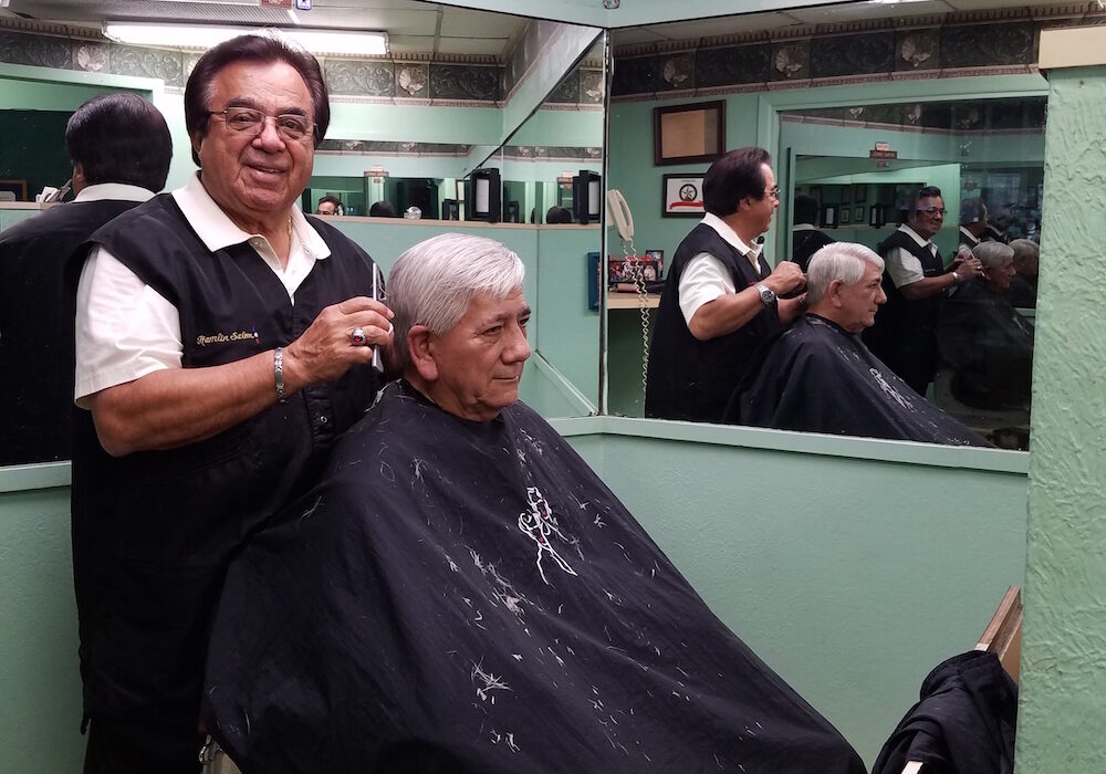 Internationally renowned hairstylist Juan ‘Johnny’ Garcia cuts the hair of longtime friend Richard Garcia, retired advertising executive from the Corpus Christi Caller-Times. ‘I’ve been getting my haircut by Johnny at Hamlin Barber Salon since the late 1960s. I don't trust anybody else,’ Garcia said. Photo by Jane Kathleen Gregorio