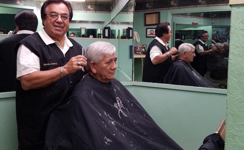Internationally renowned hairstylist Juan ‘Johnny’ Garcia cuts the hair of longtime friend Richard Garcia, retired advertising executive from the Corpus Christi Caller-Times. ‘I’ve been getting my haircut by Johnny at Hamlin Barber Salon since the late 1960s. I don't trust anybody else,’ Garcia said. Photo by Jane Kathleen Gregorio