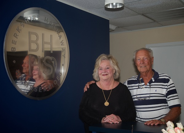 Jacqueline Svoboda with her husband, Hank, by her company’s new logo for Berkshire Hathaway HomeServices Real Estate Center. The Svobodas have been involved in Corpus Christi real estate for 37 years. Hank Svoboda owns Padre Island Realtors. Courtesy Photo