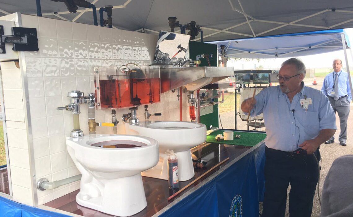 An examiner from the Texas State Board of Plumbing Examiners, Ed Rouse, demonstrates improper toilet plumbing installation and its consequences at a backflow demonstration in Corpus Christi May 17, 2017. Courtesy photo