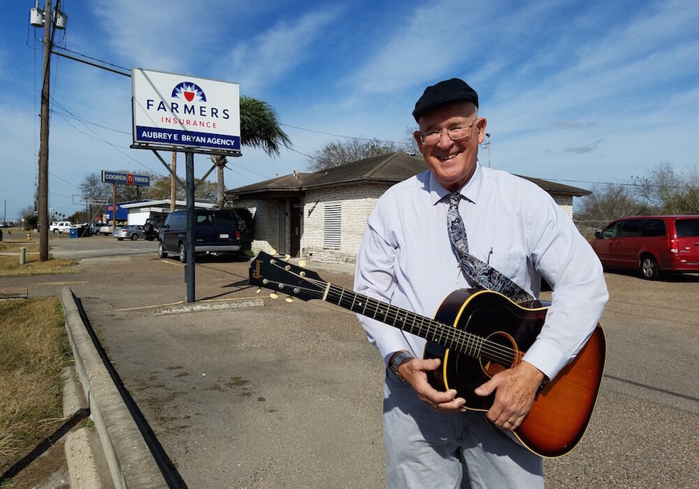 Aubrey Bryan with his prized possession, a 1965 Gibson J-45 guitar, the same type used by Elvis Presley. Bryan purchased his in 1967 from a San Antonio music store. It’s still in good condition. Photo by Jane Kathleen Gregorio