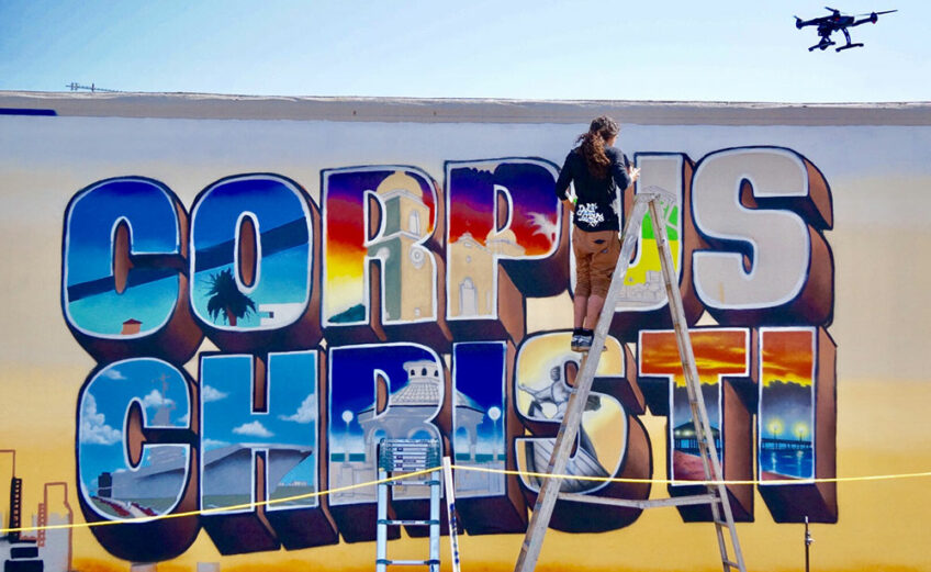 Muralist Jeremy Flores at work on the city’s latest mural. He spent much of 2017 brightening the downtown area. ‘I got a lot better over the past year,’ he said. ‘I can get a lot more detail.’ Courtesy photo