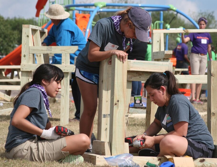 Marisa Herrera (left), Randi Villarreal and Analisa Cortinez, all city of Corpus Christi Latch Key employees, help build a deck bench for the new playground at Dilworth Park on Nov 5. Photo by Carrie Robertson Meyer/Third Coast Photo
