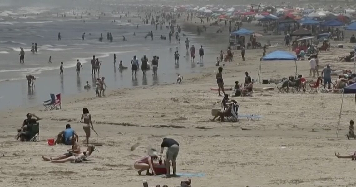 This screenshot was taken from a San Antonio TV news station's footage of the beach in Port Aransas on Memorial Day weekend. Beaches in Port Aransas and Corpus Christi were packed for the long weekend, which experts believe led to a surge in COVID-19 cases that put the city in The New York Times as the top city in the nation for positive cases per capita.