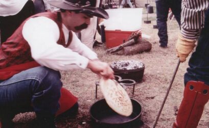 A cowboy prepares tortas over an open fire at the Ranch Hand Breakfast held the Saturday before Thanksgiving every year at the King Ranch. Courtesy Photo