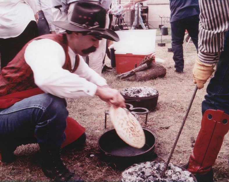 A cowboy prepares tortas over an open fire at the Ranch Hand Breakfast held the Saturday before Thanksgiving every year at the King Ranch. Courtesy Photo