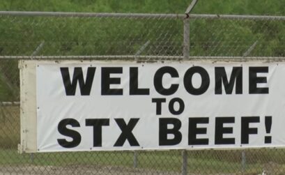 An STX Beef sign covers the entrance gate at the former Kane Beef plant on Leopard Street in Corpus Christi. The plant reopened under new ownership March 25. It had closed in January after filing for bankruptcy.