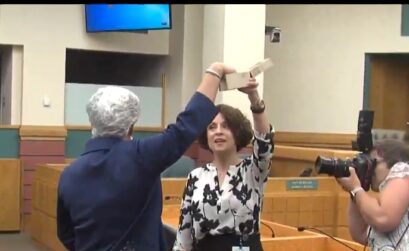Former mayor and current mayoral candidate Nelda Martinez draws a number from a box held by Corpus Christi City Secretary Rebecca Huerta on March 28. A second drawing set for April will likely be cancelled now that Mark Scott has dropped out of the race. Courtesy photo