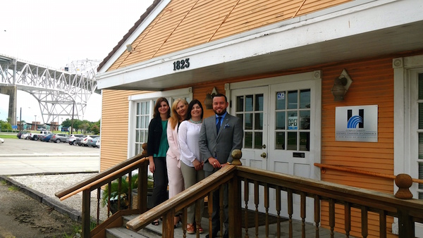 With the Harbor Bridge in the background, chamber staff proudly stand in front of their new office at 1823 N. Chaparral St. in Corpus Christi. On the steps of the former Tex-Mex Railway Depot are (from left) communications liaison Deborah Teixeira, president and CEO Teresa Rodriguez Bartlett, director of business development Amanda Elizondo and director of membership services David Davila. The chamber moved into is new home in June of this year, and recently remodeled it. Photo by Jennifer O'Neill