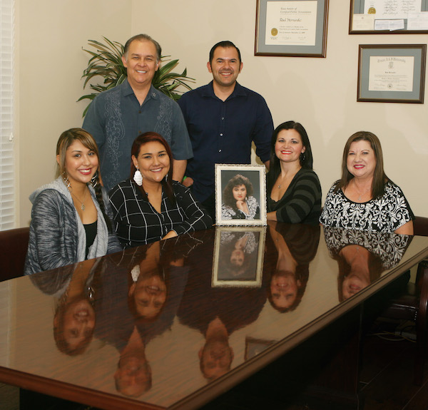 The gang (minus the grandkids) at Raul Hernandez and Company, P.C. Certified Public Accountants in Corpus Christi, along with a picture of Raul and Sylvia’s daughter Jennifer Delos Santos, who passed away in 2011. Photo by Carrie Robertson Meyer/Third Coast Photo