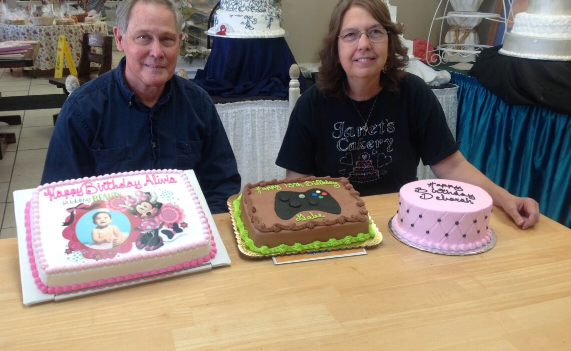 Patrick Limerick, Janet’s Cakery owner and head baker, and Joy Richards, bakery co-manager, with just a few of the day’s cake creations, including an example of a birthday cake with a photograph done in icing. Photo by Suzanne Freeman