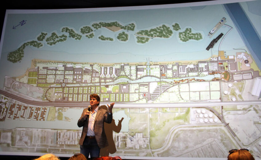Standing in front of a packed house, developer Jeff Blackard presents a conceptual video illustrating the solutions for drainage and shoreline protection for North Beach. The ideas from the North Beach Infrastructure Task were presented at a stakeholder meeting at the Texas State Aquarium in early April. Photo by Carrie Robertson Meyer/Third Coast Photo