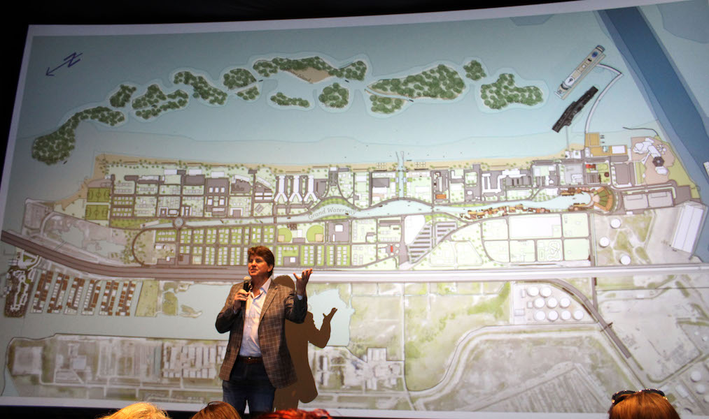 Standing in front of a packed house, developer Jeff Blackard presents a conceptual video illustrating the solutions for drainage and shoreline protection for North Beach. The ideas from the North Beach Infrastructure Task were presented at a stakeholder meeting at the Texas State Aquarium in early April. Photo by Carrie Robertson Meyer/Third Coast Photo