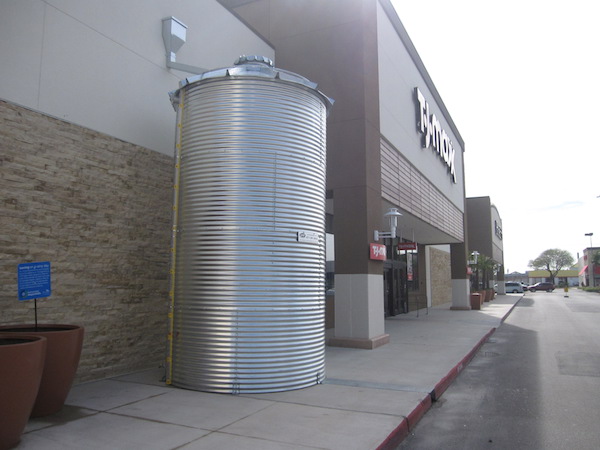 "No, it’s not a big barrel of oil, but its contents are just as valuable to us," reads a sign by the 5,300-gallon cistern at The Shops at La Palmera in Corpus Christi. Staff Photo