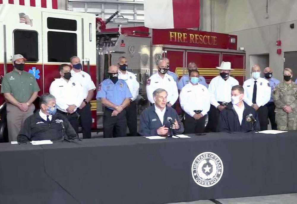 Flanked by members of the Corpus Christi Fire Department, including Chief Robert Rocha (left at table), Gov. Greg Abbott announced a Save our Seniors Initiative to begin statewide on Monday, March 1. The program to vaccinate all Texans ages 65 and older by the end of March is based on the city’s model. Screen-captured image