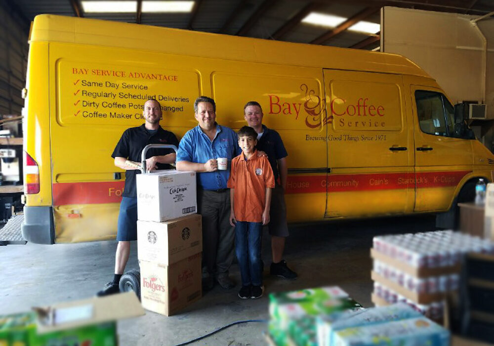 The Bay Coffee Service family (from left) Brent Mills,  President Paul Munson with his son William "Willy" Munson and Chris Burleson stand ready to keep break rooms around the Coastal Bend stocked with coffee and accessories. Photo by Jane Kathleen Gregorio