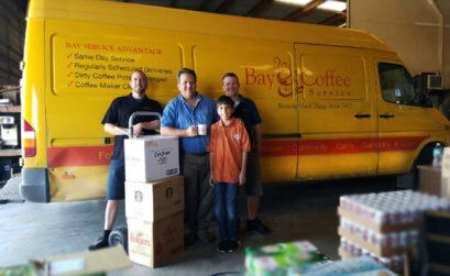 The Bay Coffee Service family (from left) Brent Mills,  President Paul Munson with his son William "Willy" Munson and Chris Burleson stand ready to keep break rooms around the Coastal Bend stocked with coffee and accessories. Photo by Jane Kathleen Gregorio