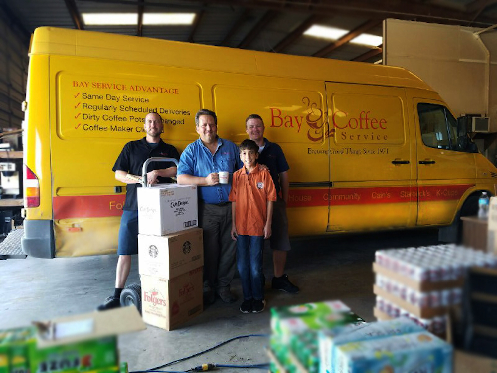 The Bay Coffee Service family (from left) Brent Mills,  President Paul Munson with his son William "Willy" Munson and Chris Burleson stand ready to keep break rooms around the Coastal Bend stocked with coffee and accessories. Photo by Jane Kathleen Gregorio