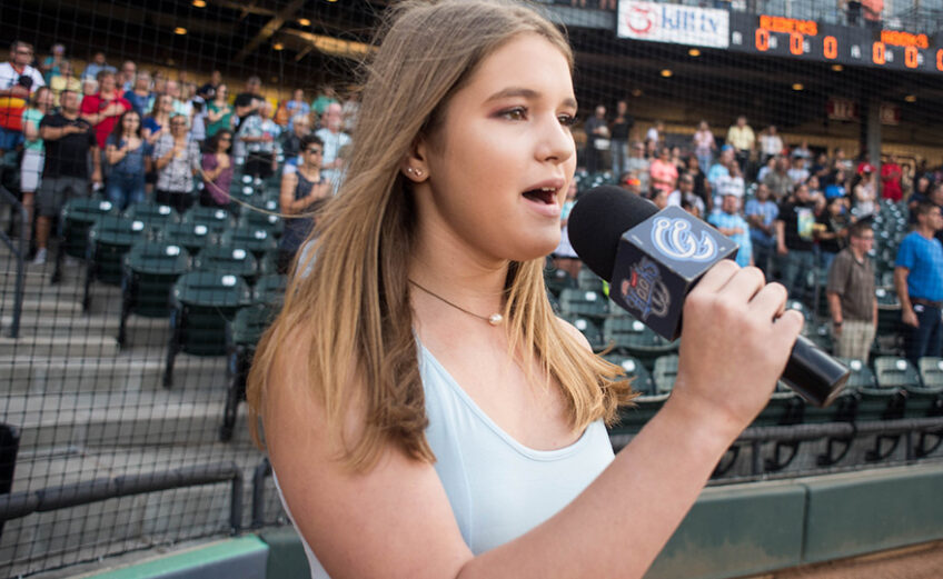 A young singer performs the National Anthem before a Corpus Christi Hooks game at Whataburger Field during a past season. Photo Courtesy Corpus Christi Hooks