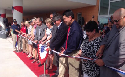 School officials line up to cut the red, white and blue ribbon officially opening the new Veterans Memorial High School in Corpus Christi. Photo by Suzanne Freeman