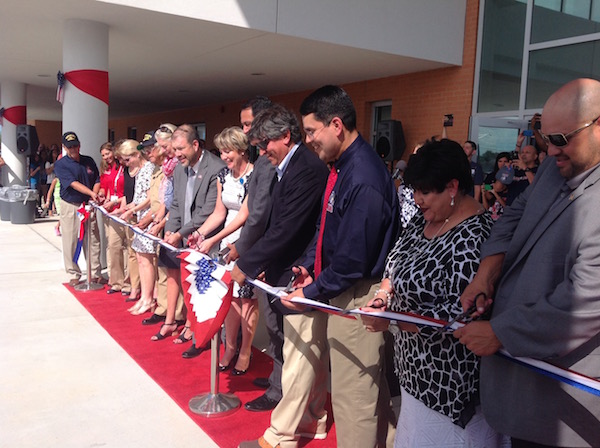 School officials line up to cut the red, white and blue ribbon officially opening the new Veterans Memorial High School in Corpus Christi. Photo by Suzanne Freeman