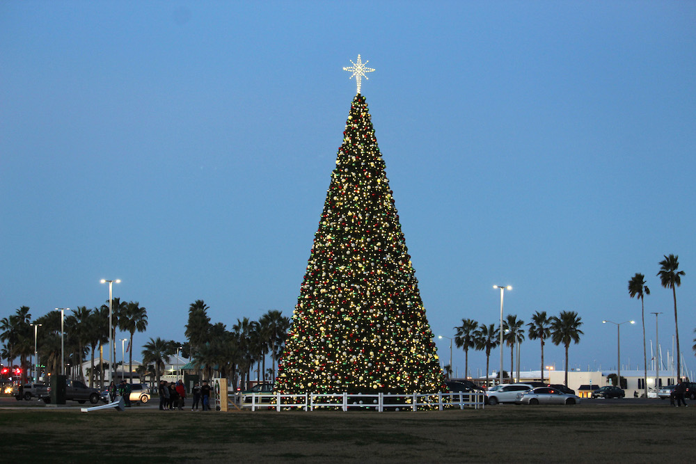 In 2018, Corpus Christi gave itself a Christmas present: a new 66-foot-tall Christmas tree with 2,000 ornaments and 7,000 lights. Although the Harbor Lights Festival centered around the tree was cancelled this year, Merry Days by the Bay is a go with new safety protocols. Photo by Carrie Robertson Meyer/Third Coast Photo