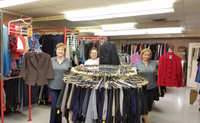 Brandishing job-appropriate jackets are Dress for Success volunteers Janet Blanke (left), client services coordinator; Gracie Solomon, donations coordinator; and Cathy Colomo Riojas, executive director. The organization’s new building is at 1620 S. Brownlee. Photo by Jane Kathleen Gregorio